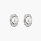 Oval rhodium-plated silver studs featuring freshwater pearls surrounded by pavÃ© crystal halo on white background