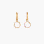 Gold-plated huggie hoop earrings with CZ-studded open circle charms on beige background