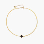 Dainty 18K gold-plated herringbone chain necklace with black enamel quatrefoil clover pendant on white background