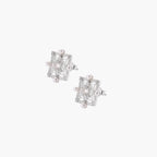 Ornate sterling silver stud earrings with mandala-inspired filigree pattern and four freshwater pearls on beige background