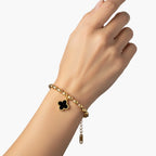 18K gold-plated oval bead chain bracelet with quatrefoil clover charm featuring mother of pearl inlay on cream background