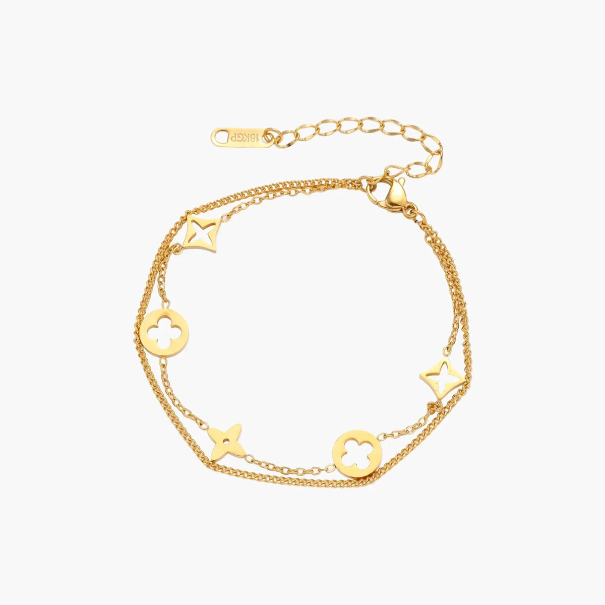 Double-layer gold-plated bracelet with quatrefoil and star charms on cream background, 18K gold finish.