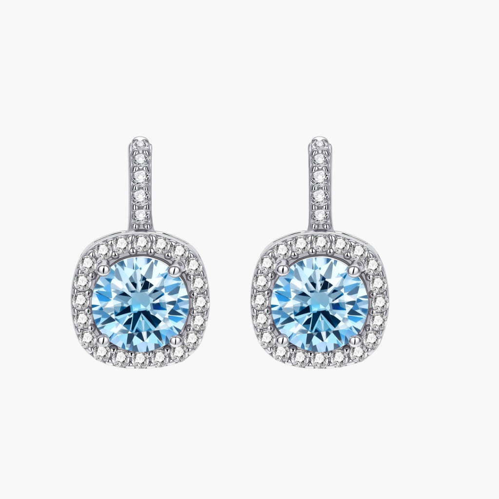 Sterling silver drop earrings featuring cushion-cut blue moissanite stones surrounded by sparkling halo settings
