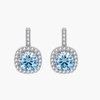 Sterling silver drop earrings featuring cushion-cut blue moissanite stones surrounded by sparkling halo settings