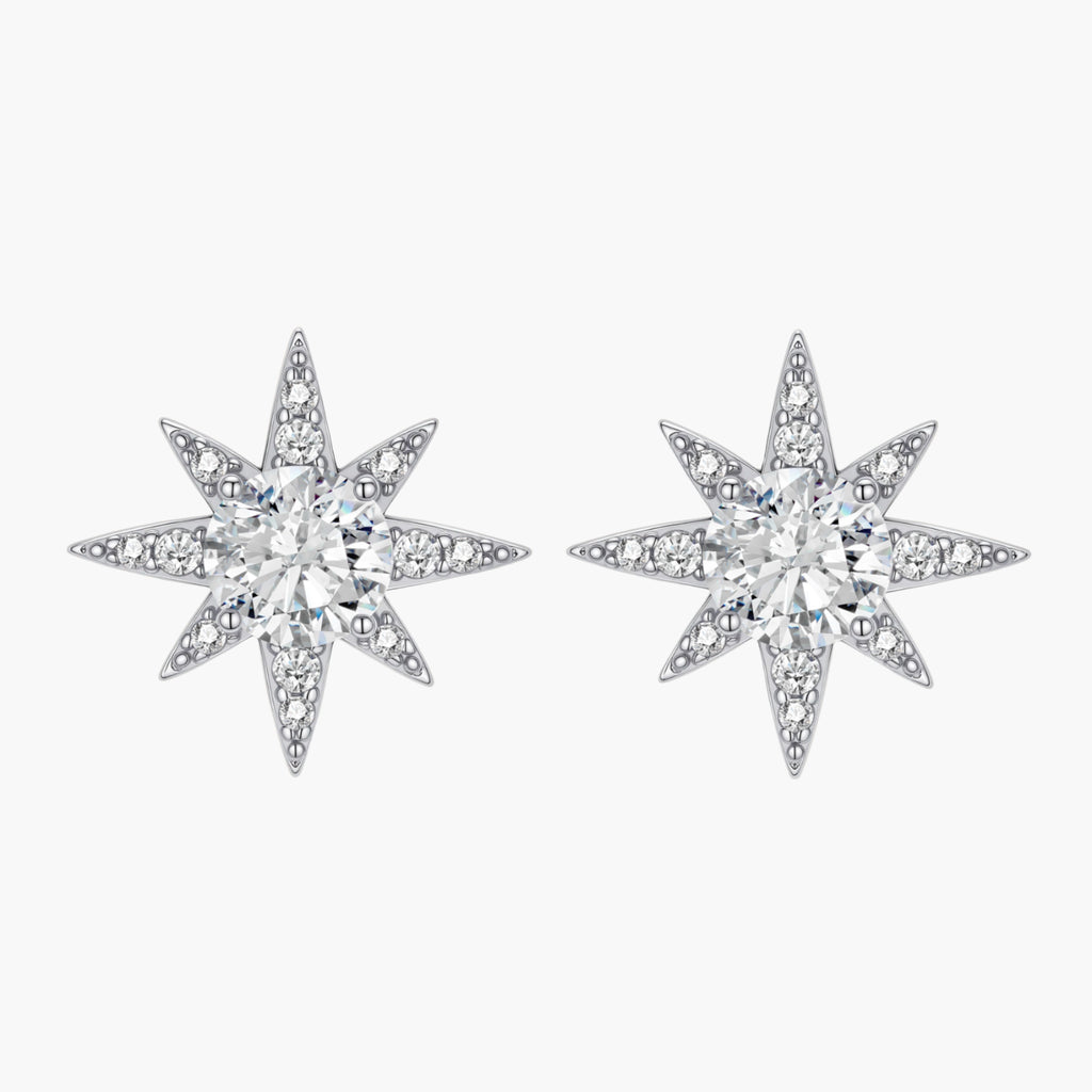 Sterling silver star-shaped stud earrings with brilliant moissanite center stones and pavé details on neutral background.