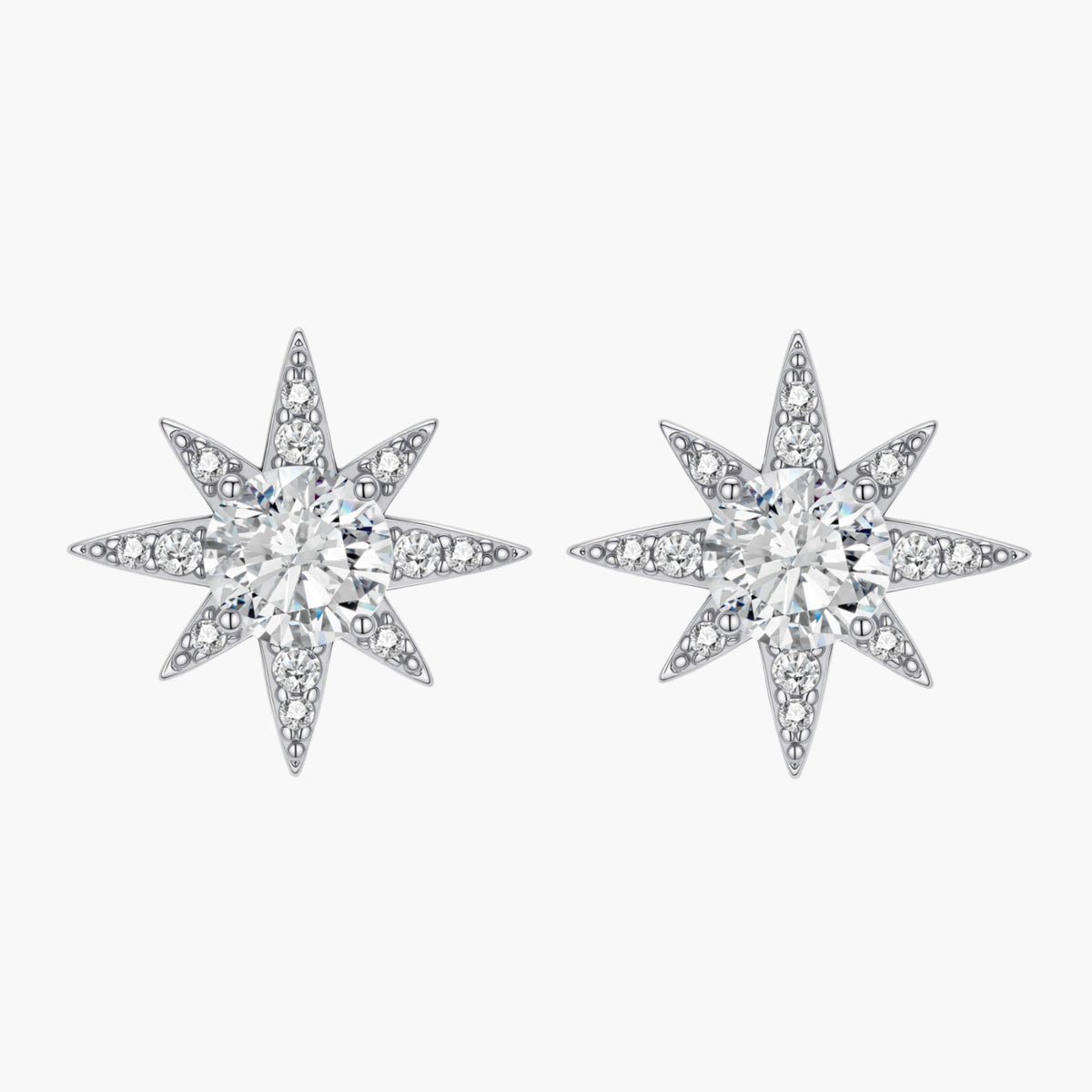 Sterling silver star-shaped stud earrings with brilliant moissanite center stones and pavé details on neutral background.