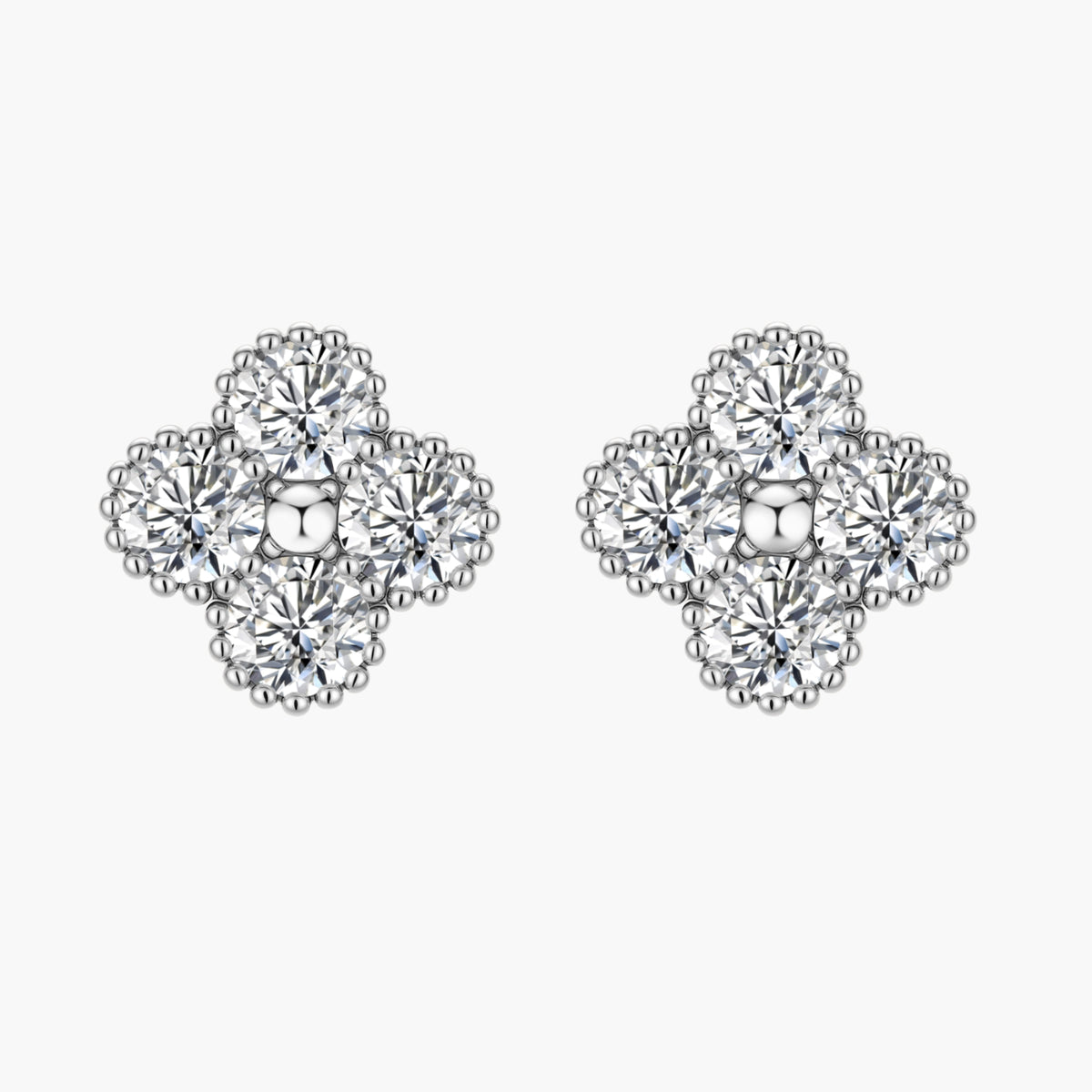 Dainty sterling silver quatrefoil stud earrings with four brilliant moissanite stones and center accent on white background.